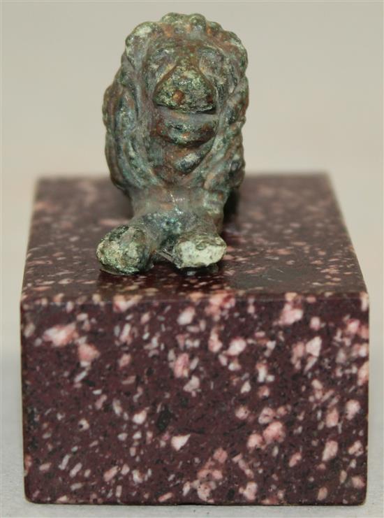 A small Roman bronze figure of a recumbent lion, c.2nd century AD, 5cm